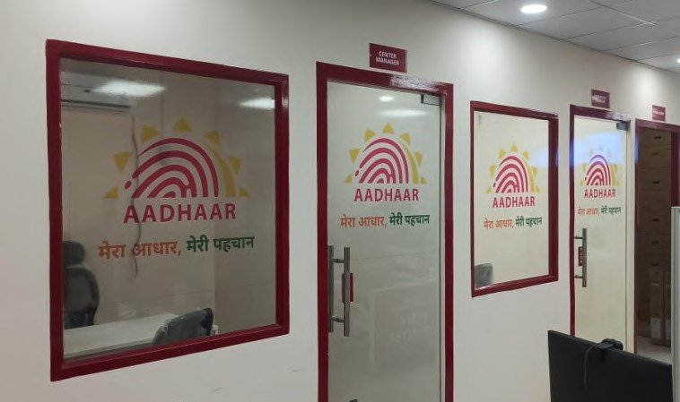 Interior glass-door signage for an Aadhaar enrolment centre